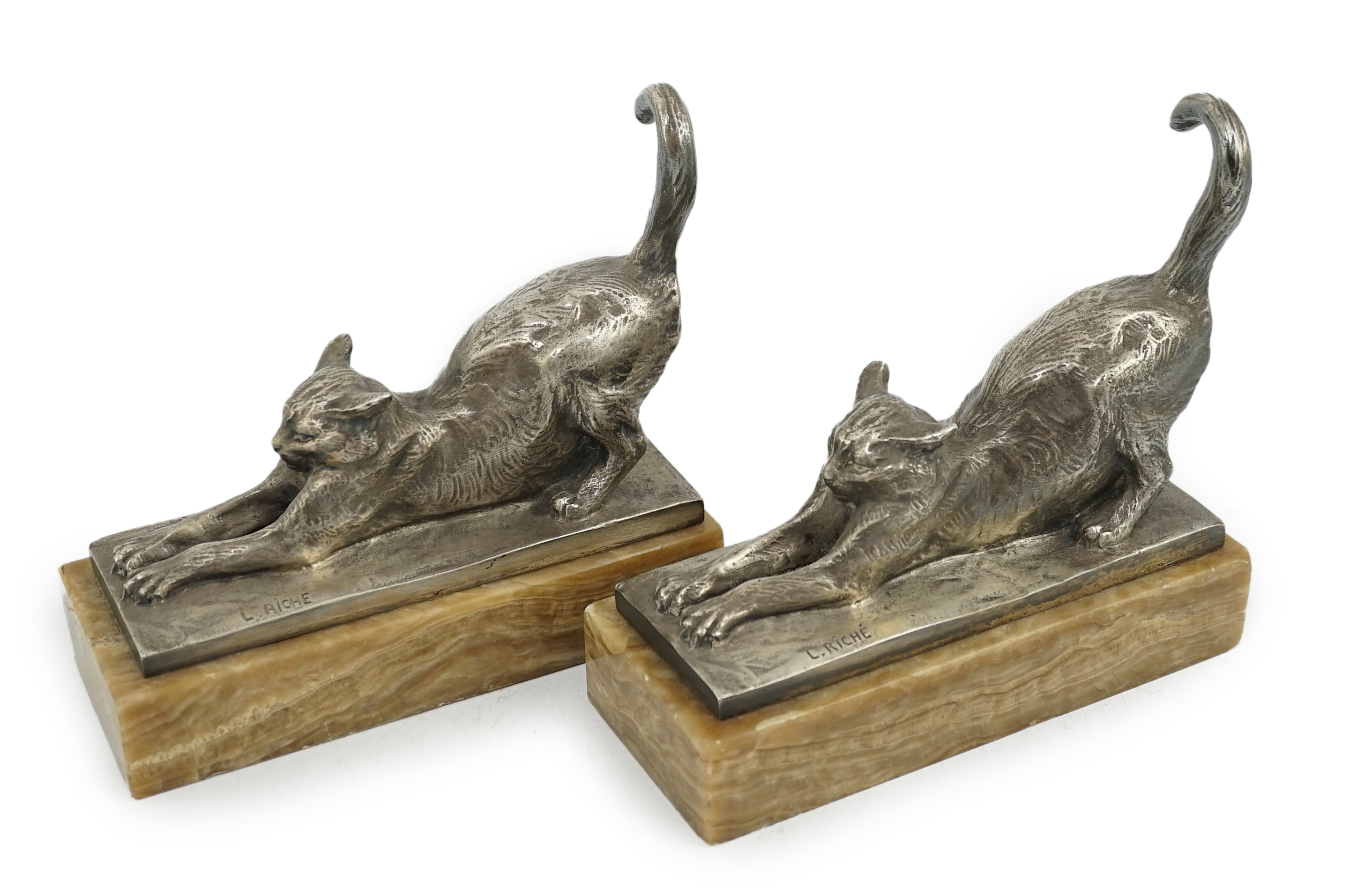 Louis Riché (French, 1877-1949), a pair of silvered bronze bookends modelled as stretching cats